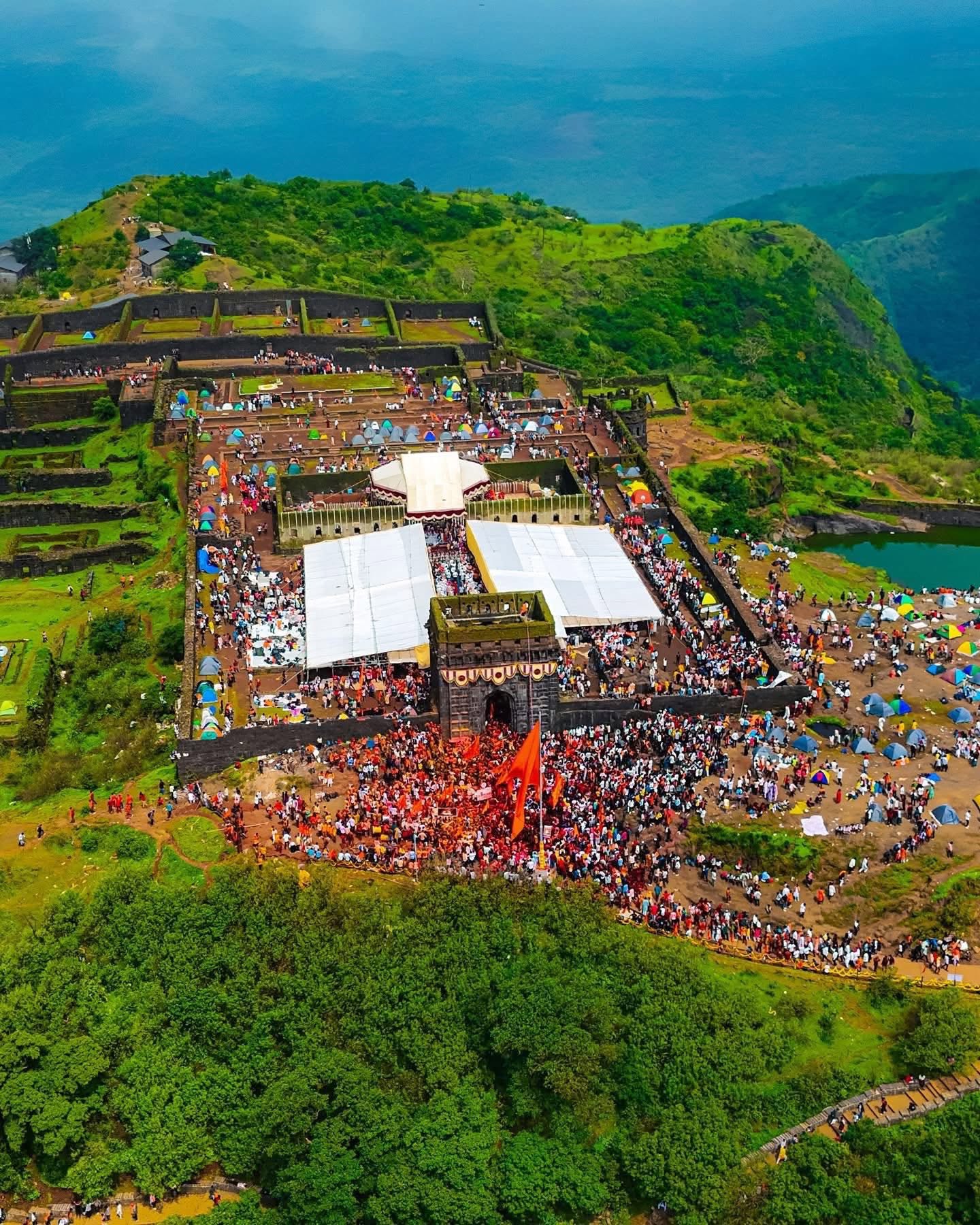 Aerial daytime view of the full Raigad Fort event setup and crowd